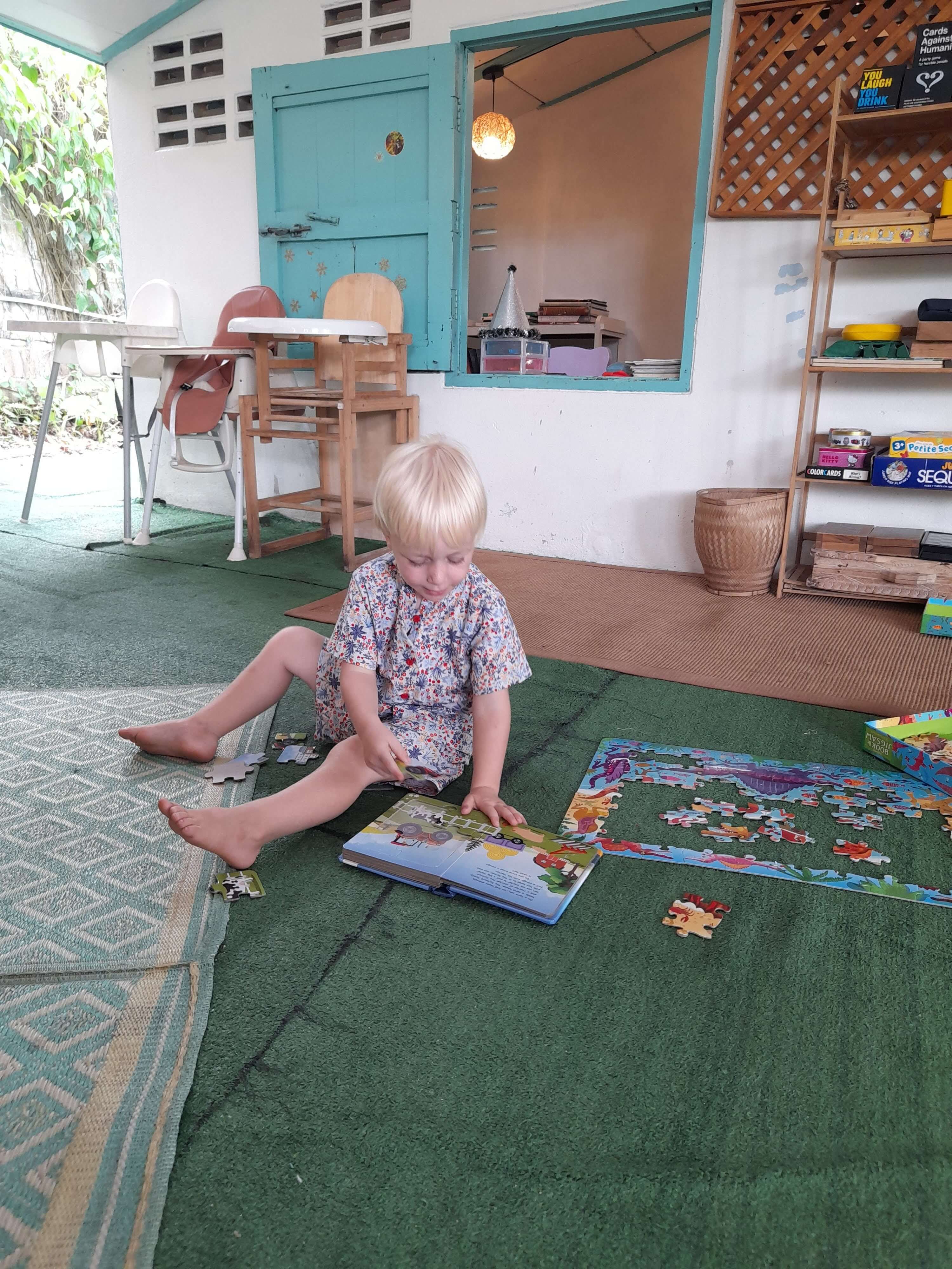 A white toddler boy planing at Fun Garden