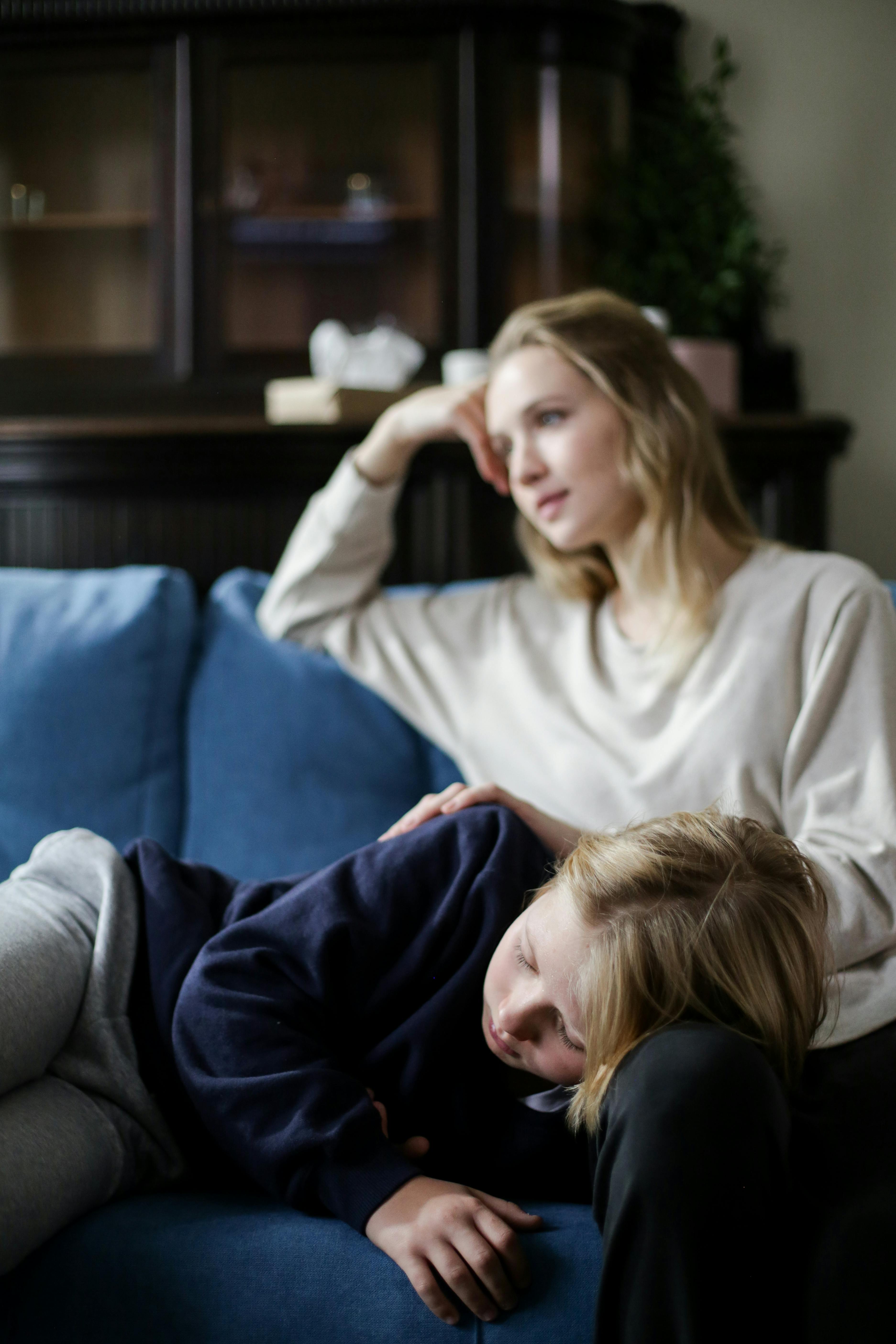 A child lies on an adults lap