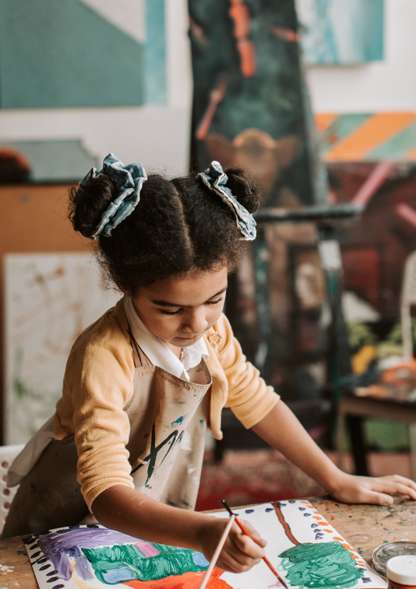 A girl draws with crayons