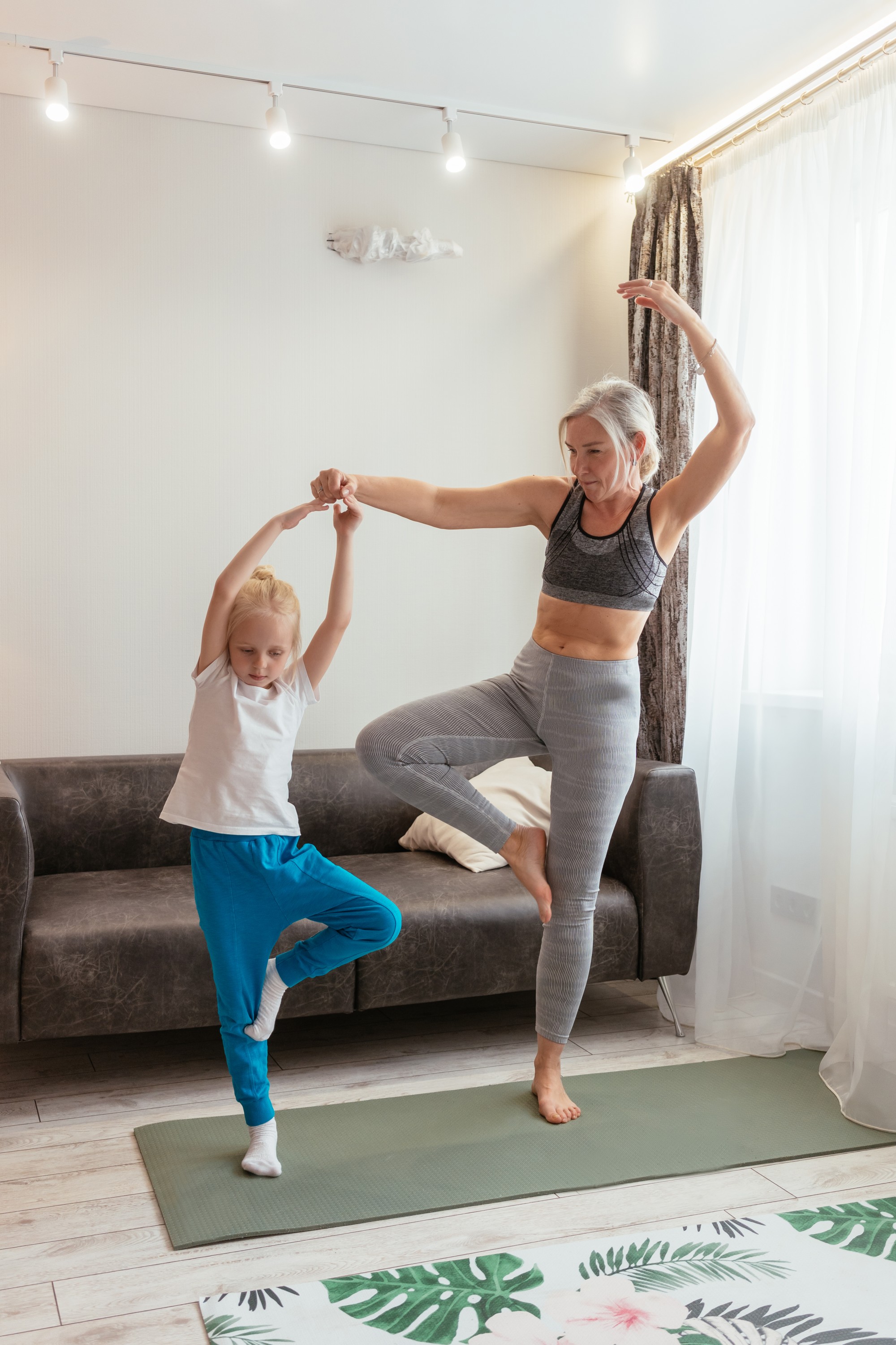 A mother and daughter do yoga together