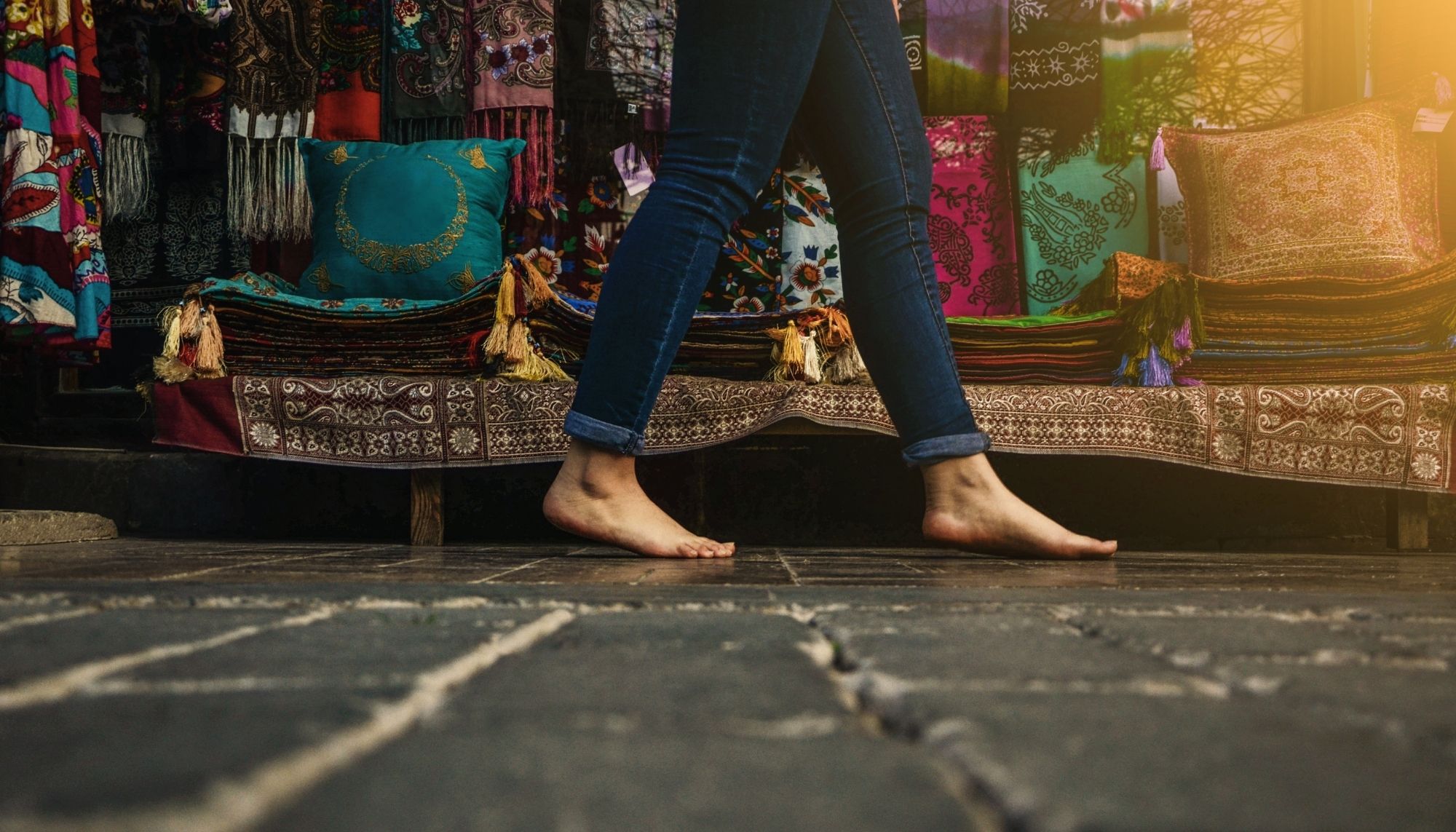 Woman walking barefoot in street