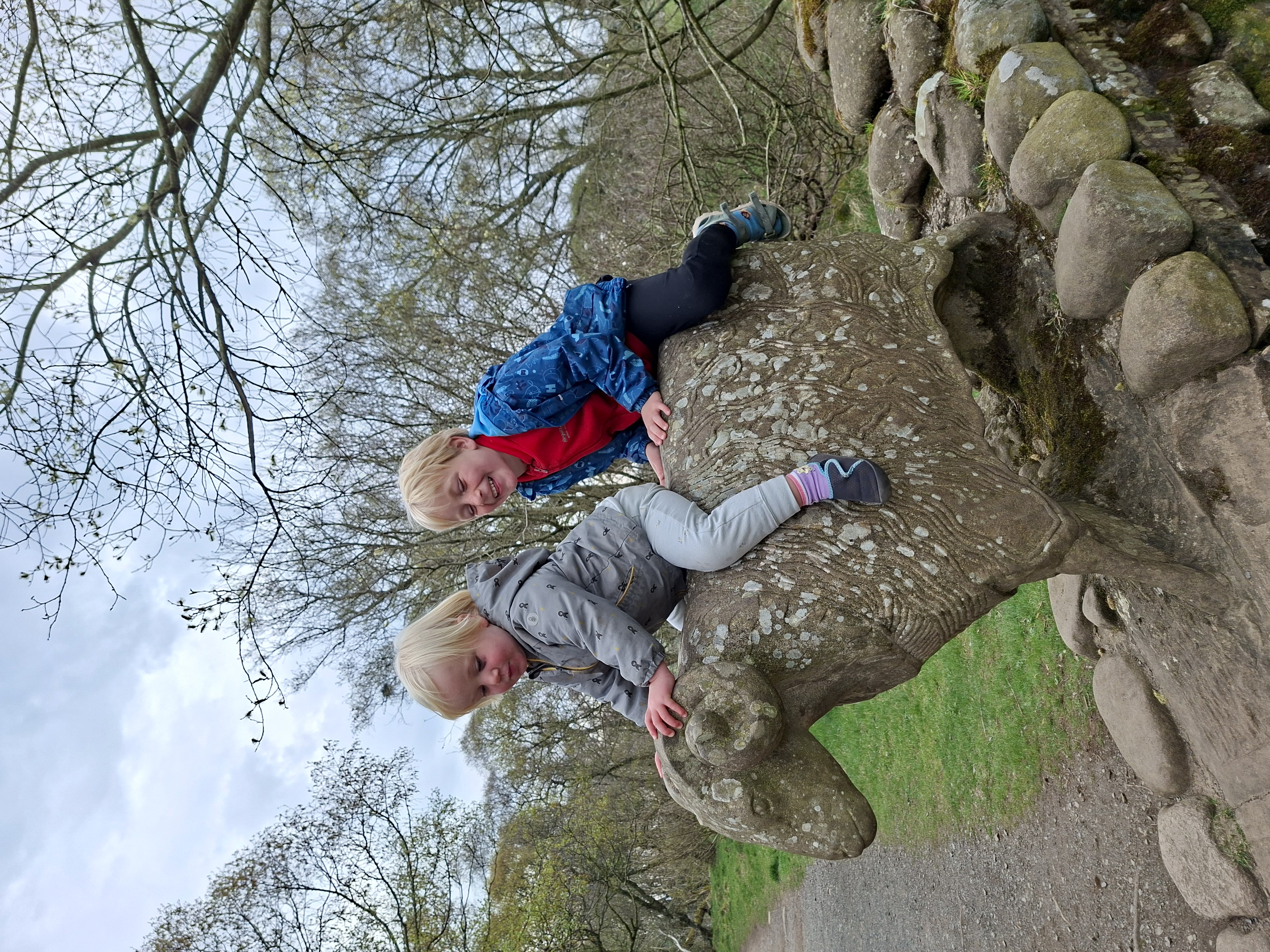 Two children on a stone sheep