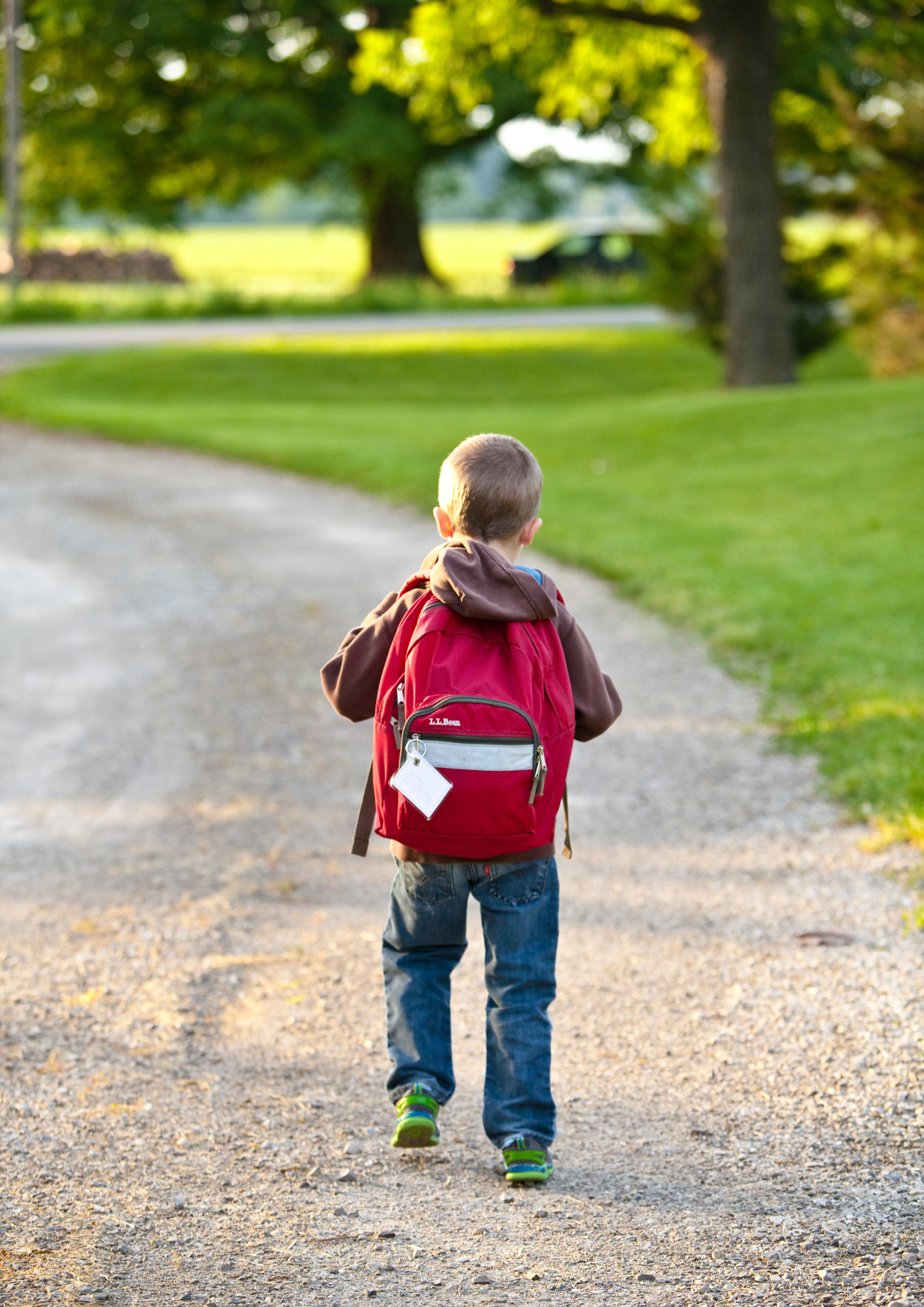 A boy carrying a backpack on his way to school