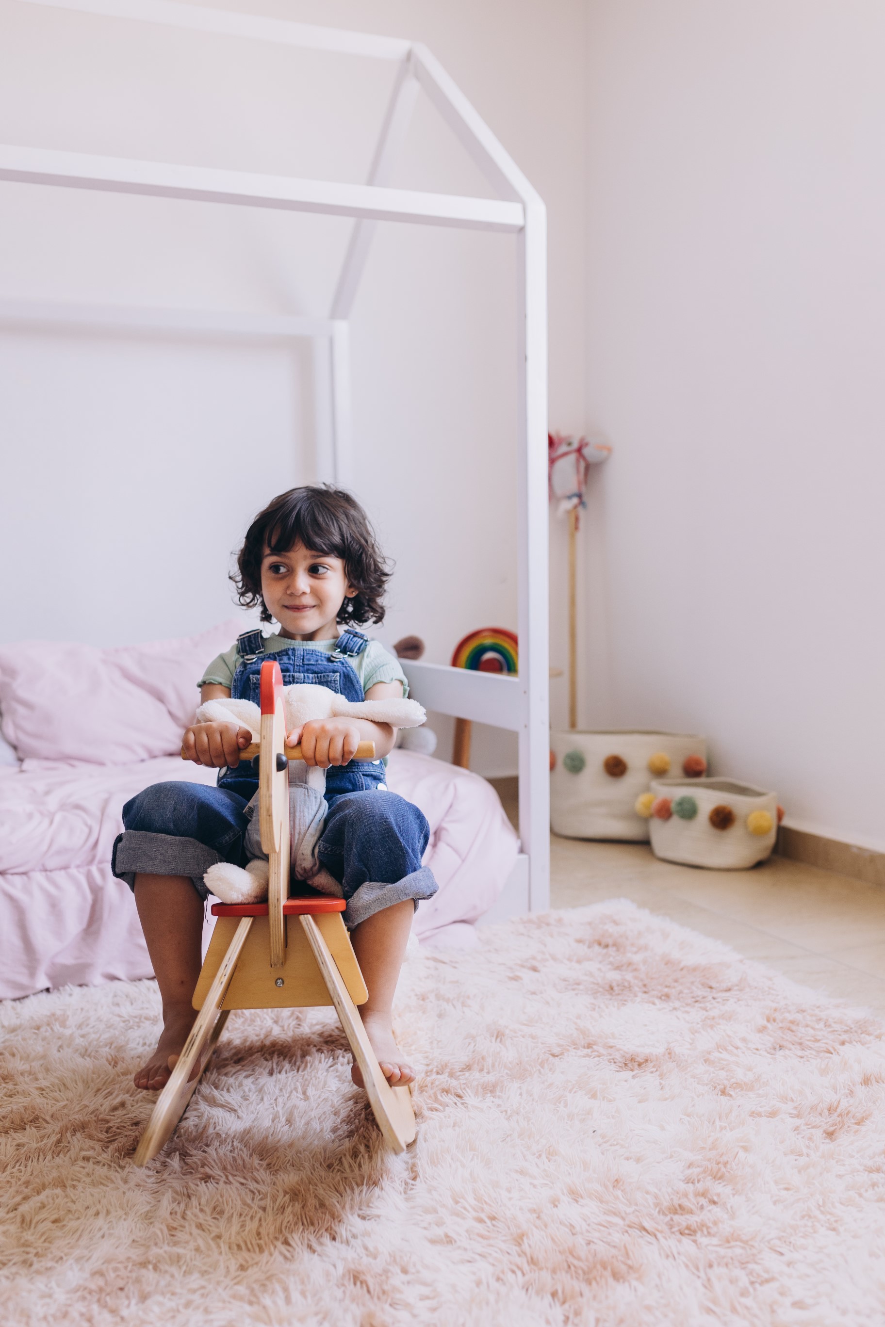 A child sits on a rocking horse.