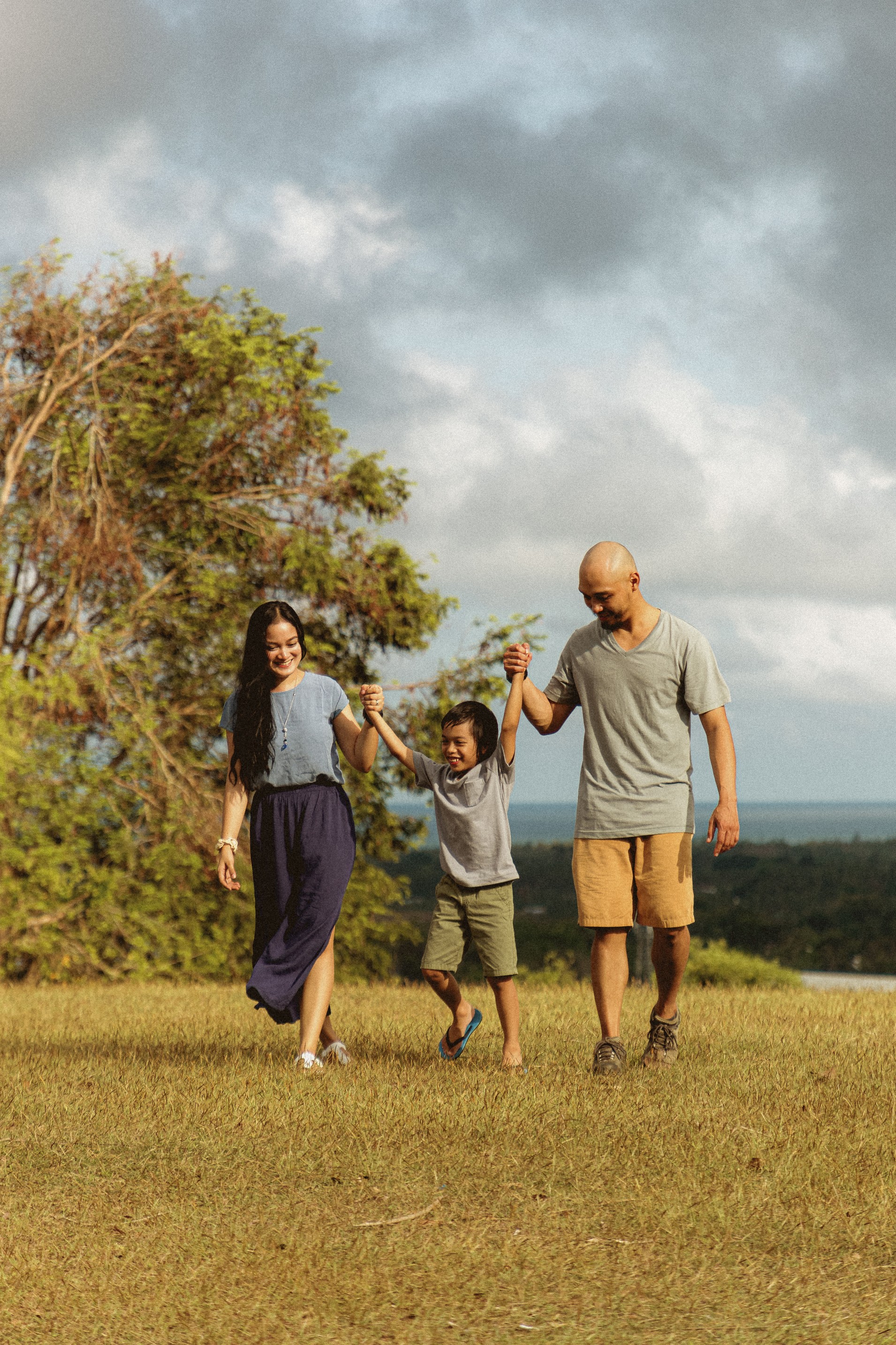 Parents swing a child