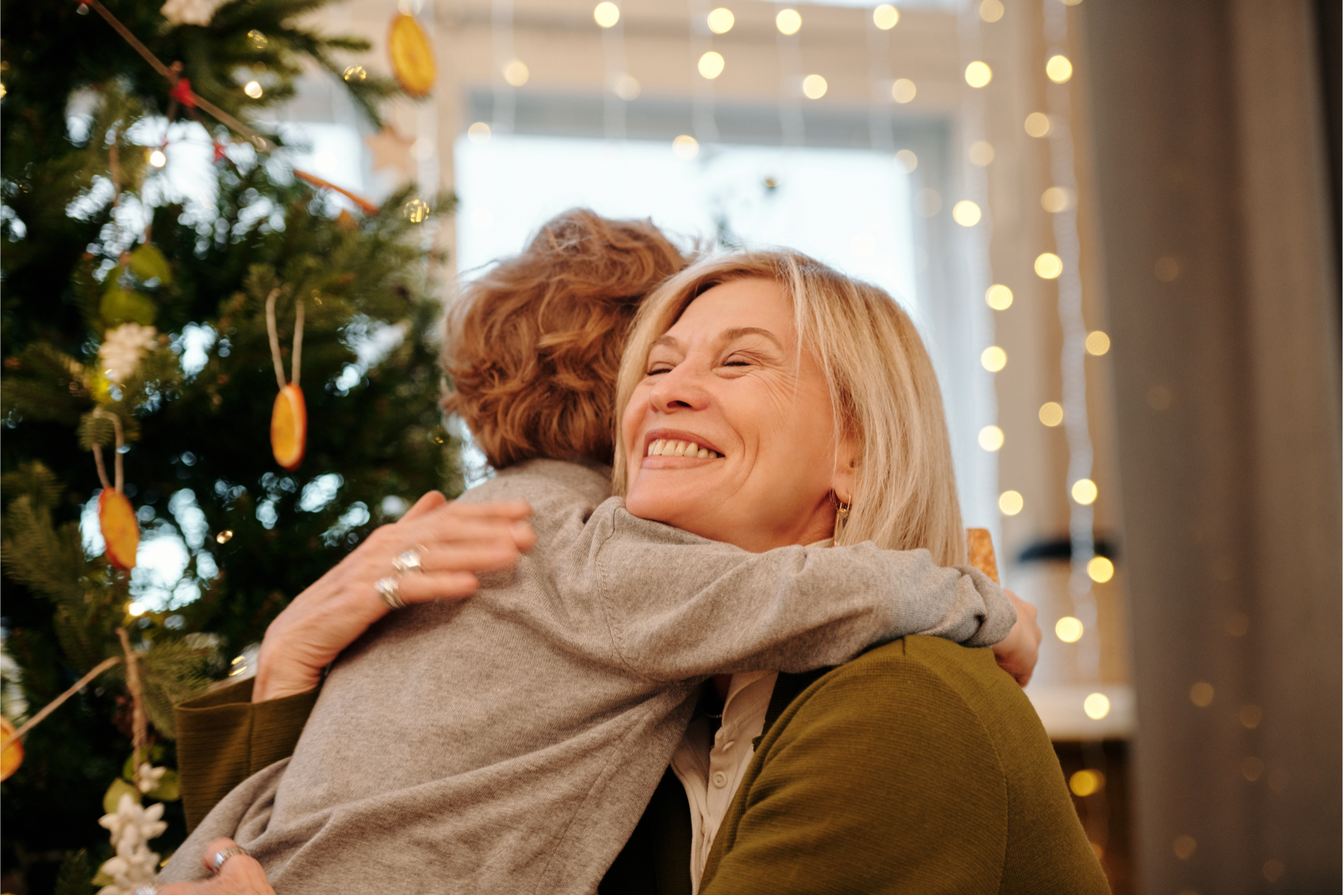 A grandmother hugging her grandchild at Christmas