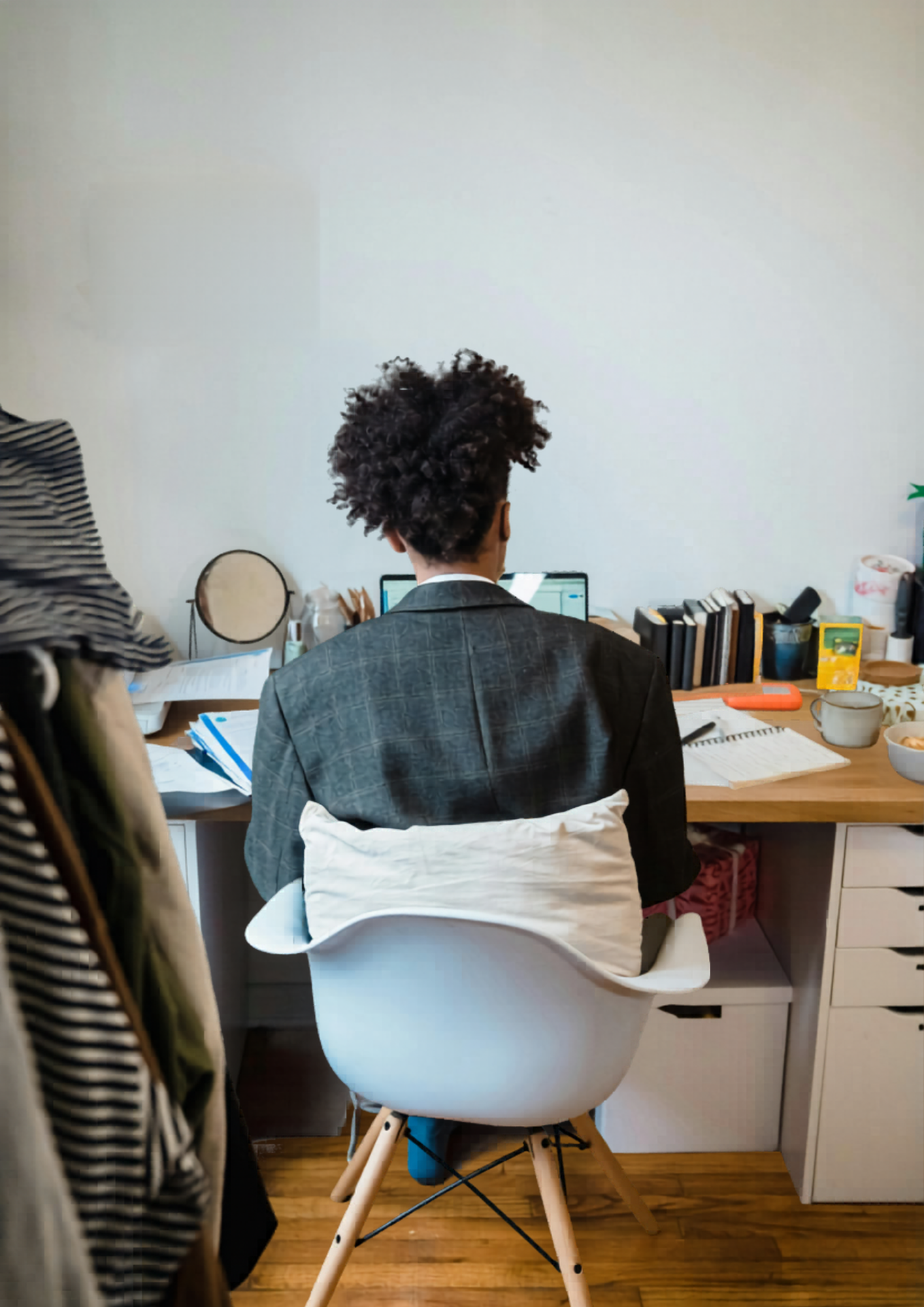 A man's back sitting at a desk
