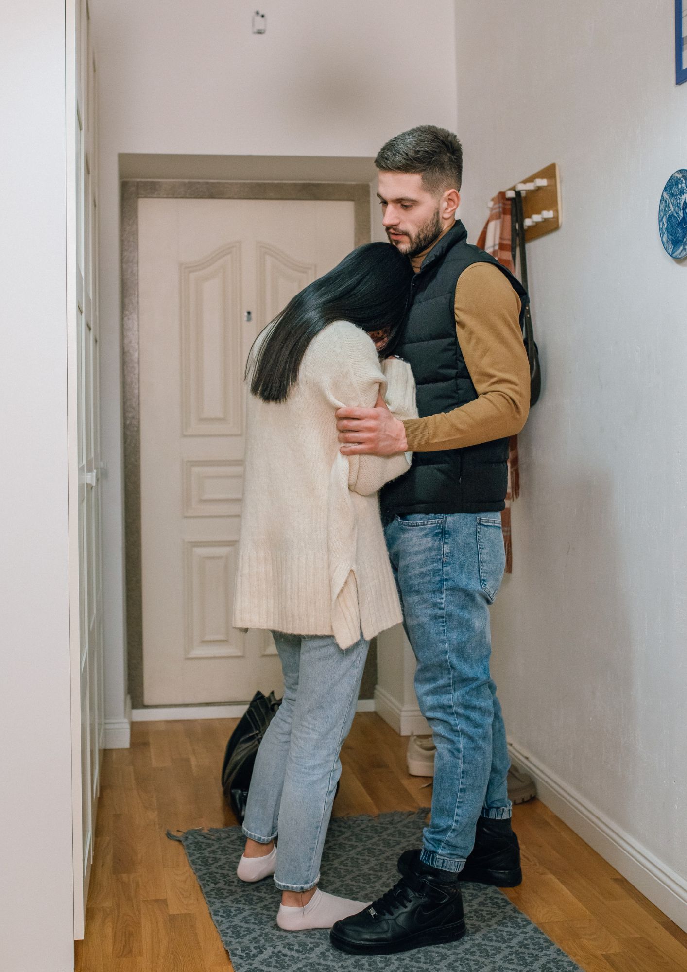 A grieving couple hug