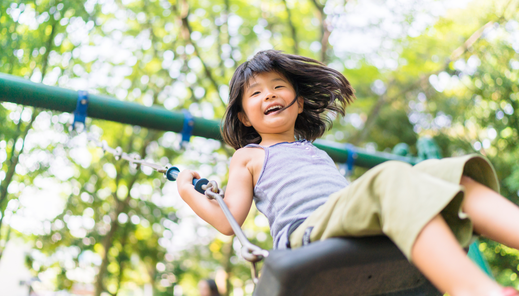 Asian girl swinging