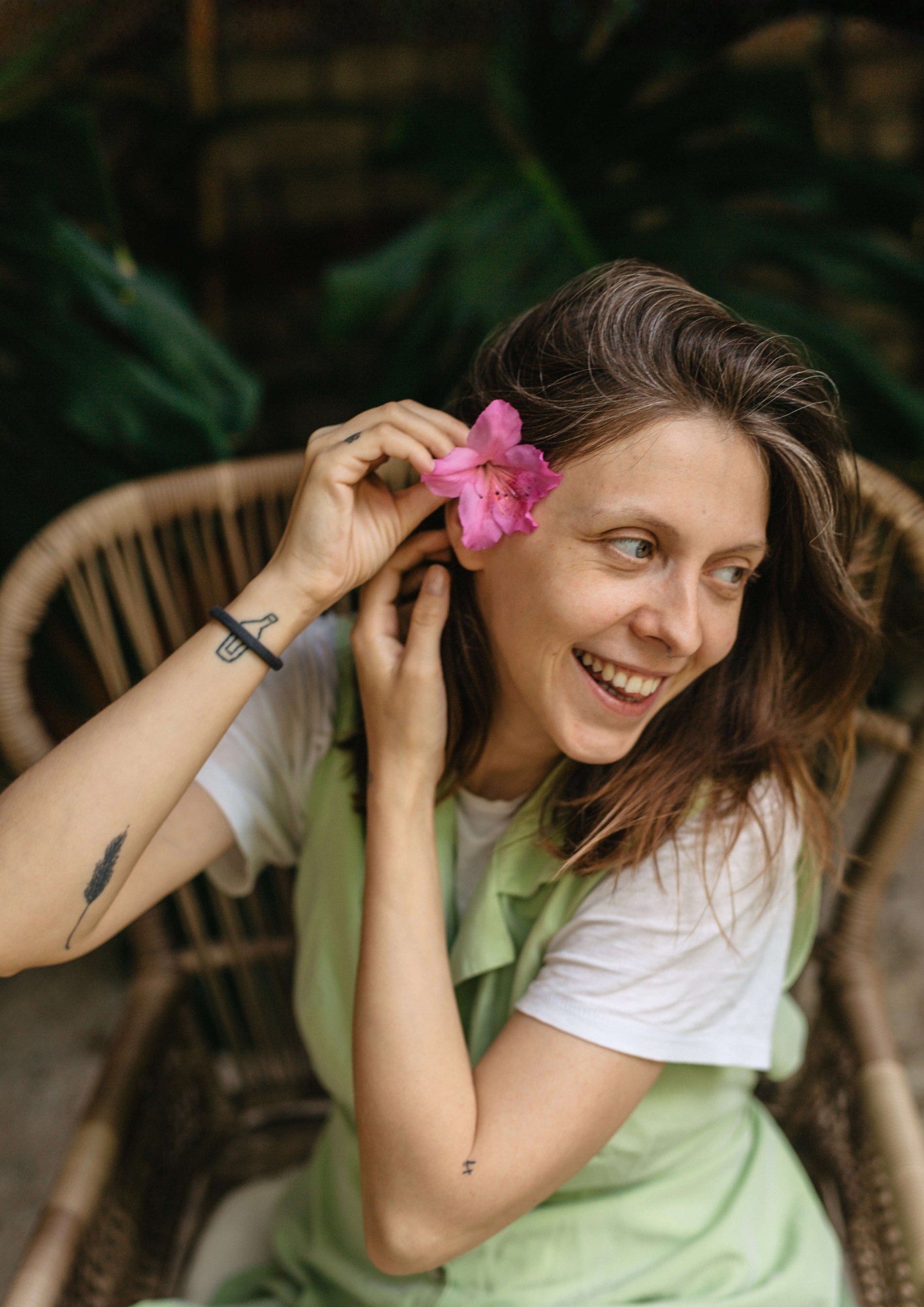 A woman puts a flower in her hair