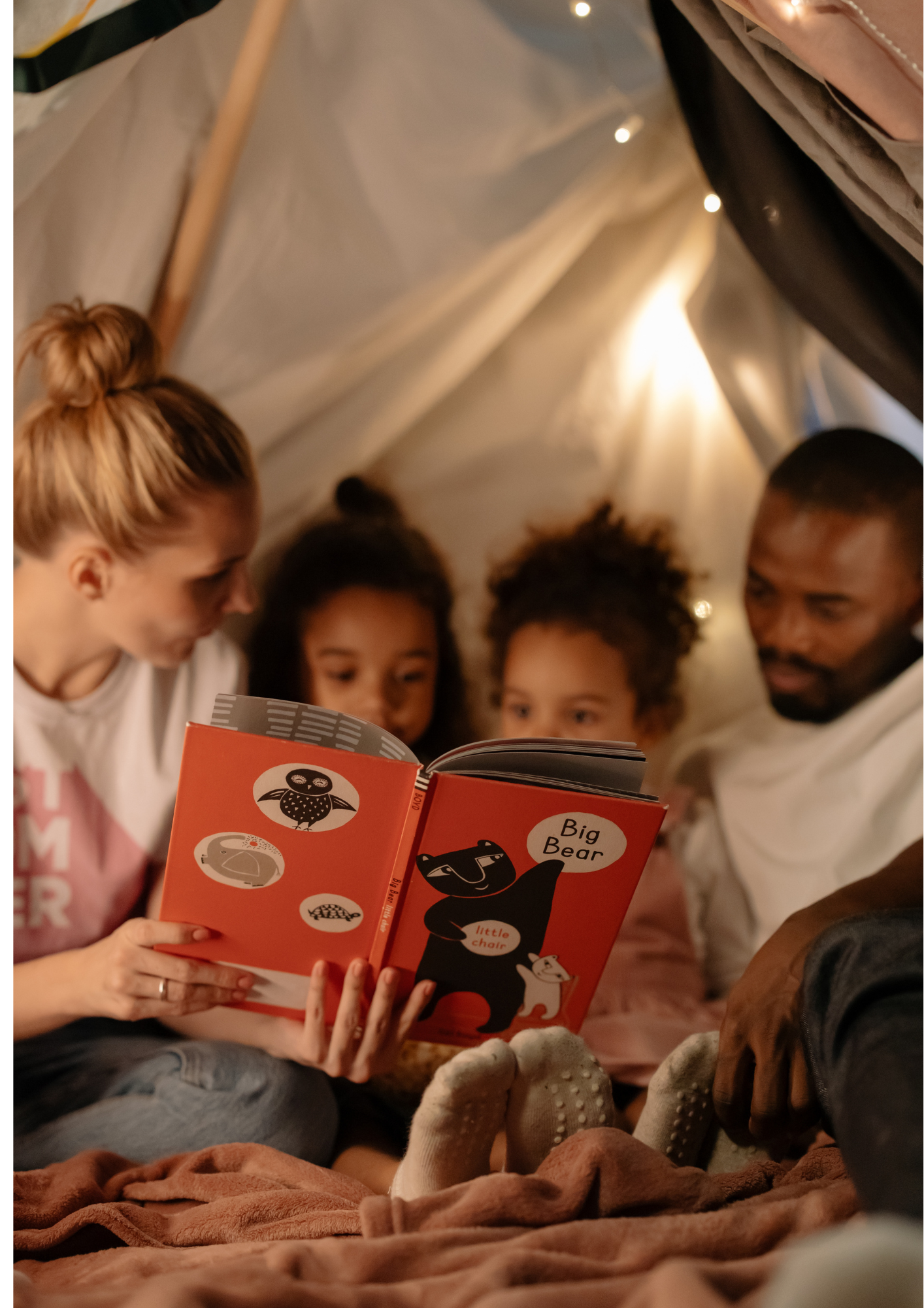 A family read in a tent