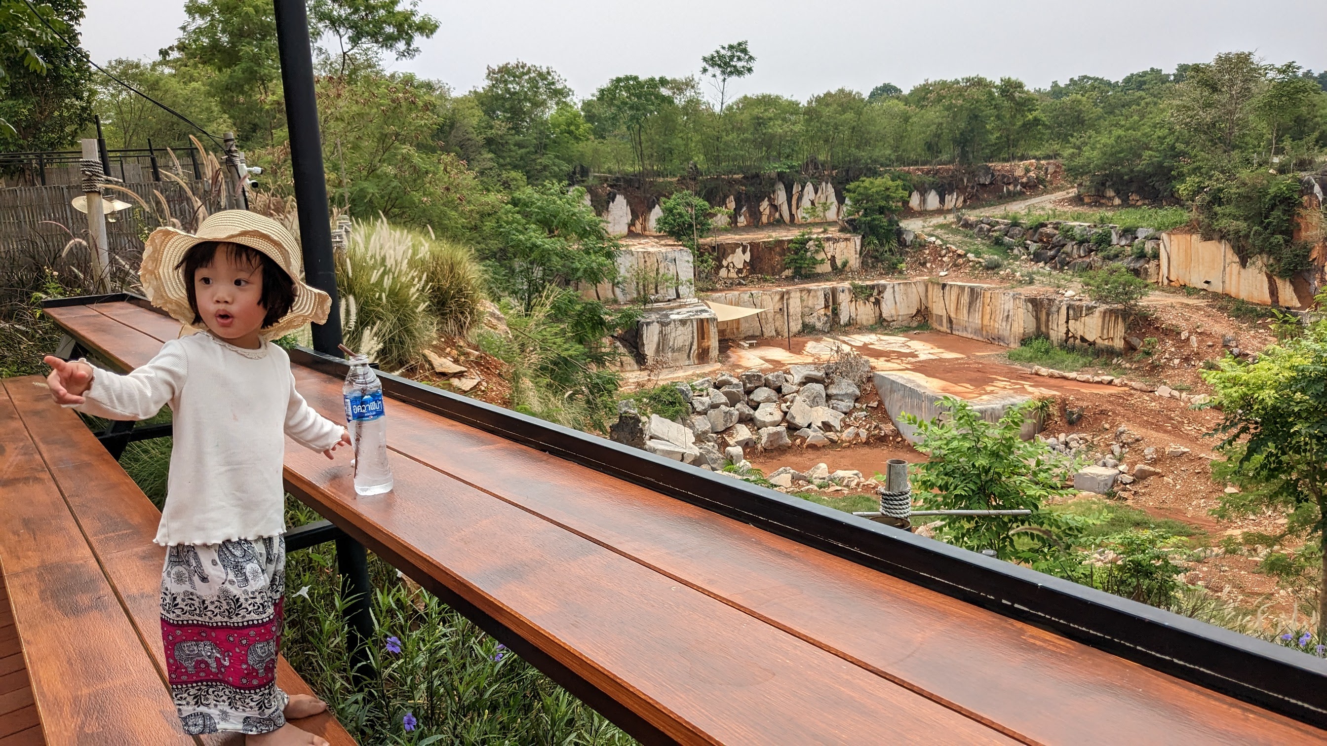 Asian girl outside pointing at something