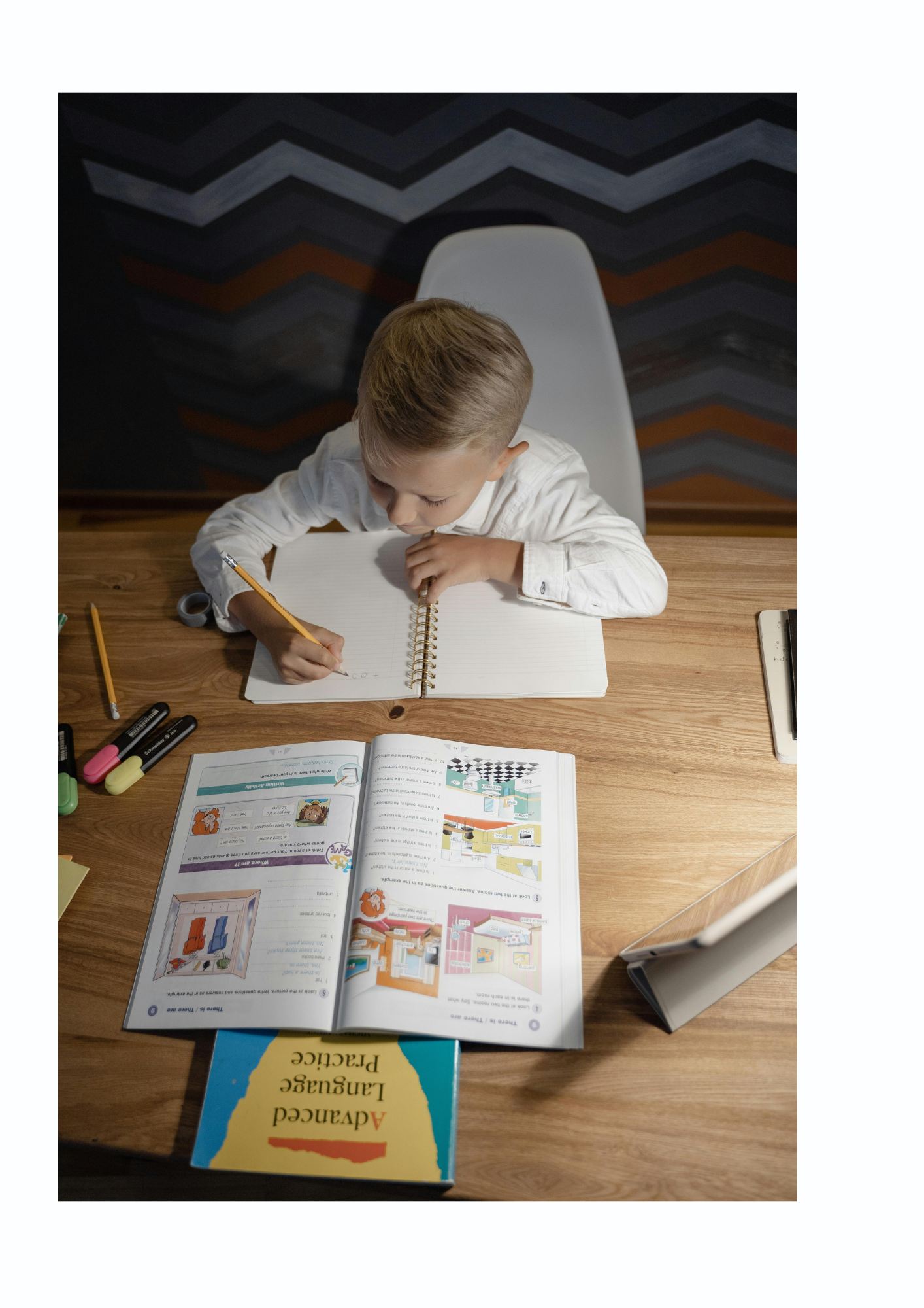 A child writes at a desk.