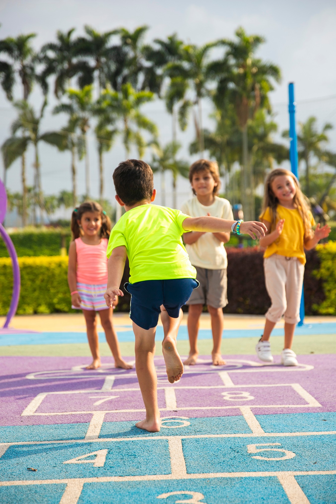 Children play hopscotch in the sun.