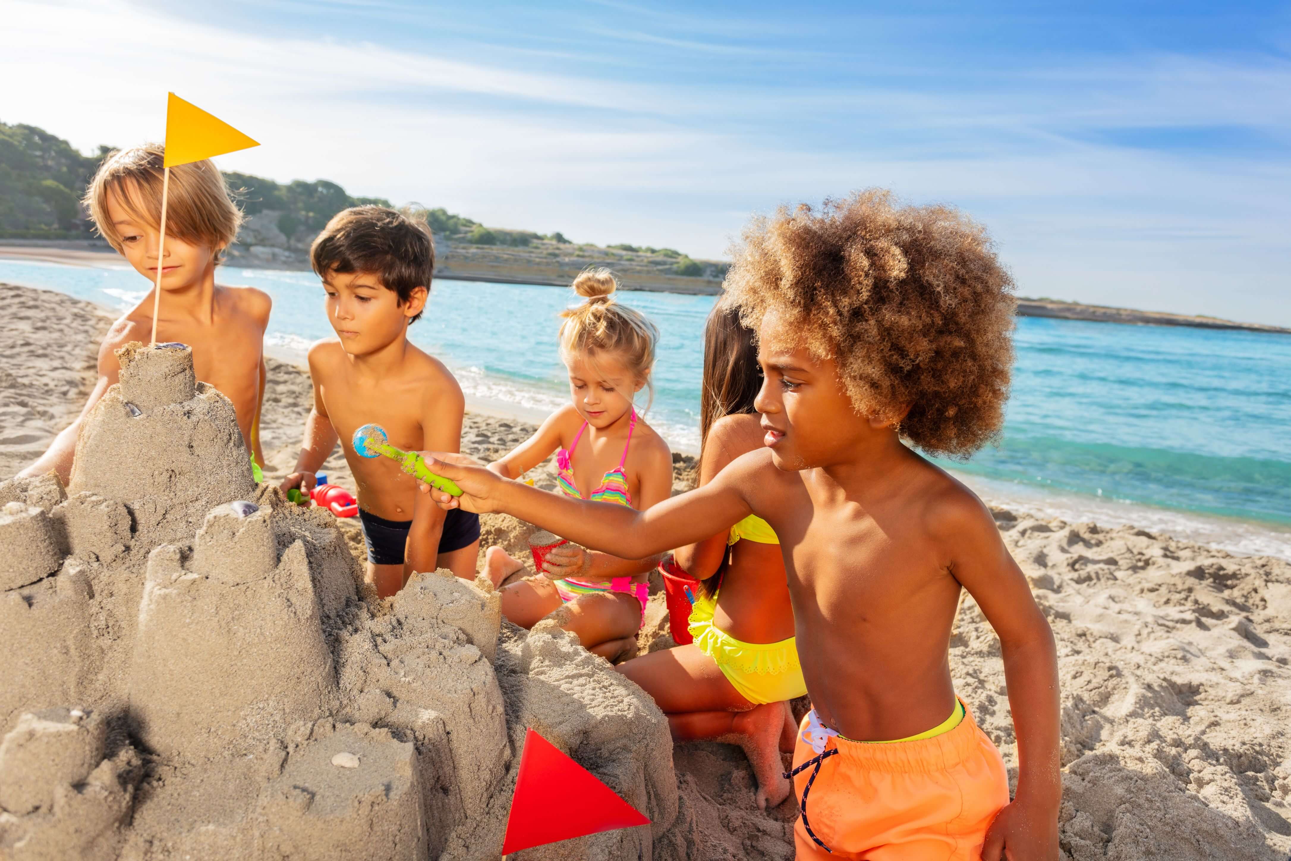 A group of children playing on the beach