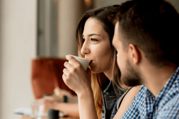 A white woman and man having coffee