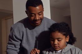 A father and daughter stand together