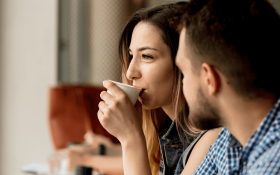 A white woman and man having coffee