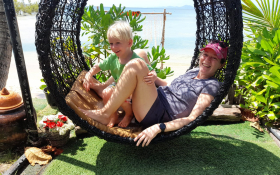A mom and her son lounging at the beach