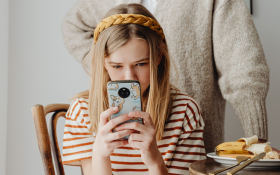 A child plays on her phone
