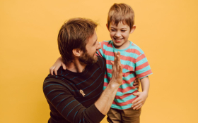 A father and child high-five