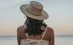 A lady's back facing the sea