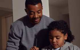 A father and daughter stand together