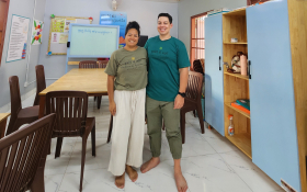 A husband and wife look at the camera