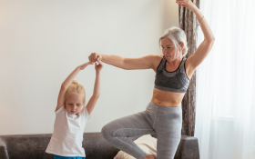 A mother and daughter do Yoga together 