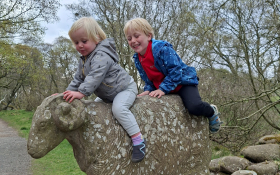 Two children on a stone sheep
